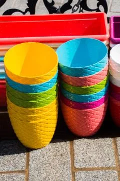 Vertical shot of a stack of colorful plastic pots Stock Photos