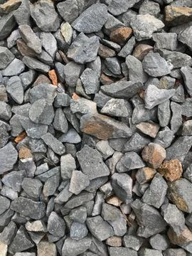 Vertical shot of a stack of dark and light gray natural pebbles Foto stock