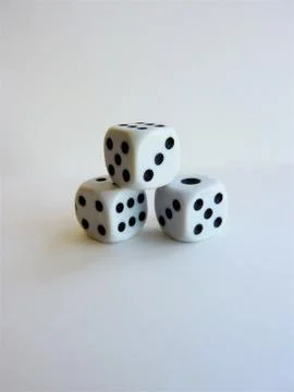 Vertical shot of a stack of dice isolated on a white background Stock Photos
