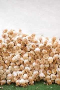 Vertical shot of stack of garlic selling at market with copy space Stock Photos