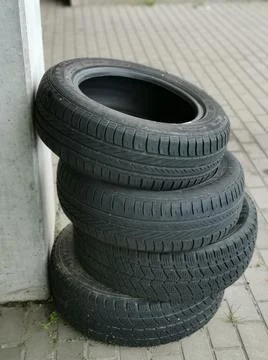 Vertical shot of a stack of used winter tires put outside the shop Stock Photos