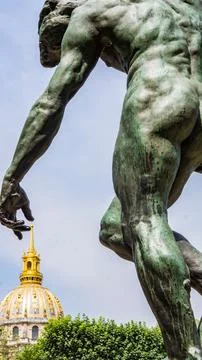 Vertical shot of the statue's hand touching Les Invalides dome.  Paris, France. Stock Photos