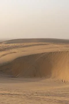 Vertical Shot of Steep Sand Dune Ridge and Car Tracks During Desert Safari. Stock Photos