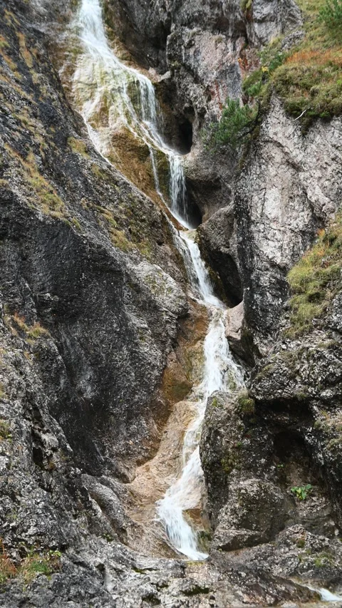 Vertical shot of a stepped waterfall in autumn, autumn colors, overcast Stock-Footage 260894637