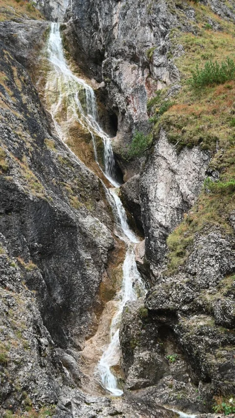 Vertical shot of a stepped waterfall in autumn, autumn colors, overcast Stock-Footage 260894797