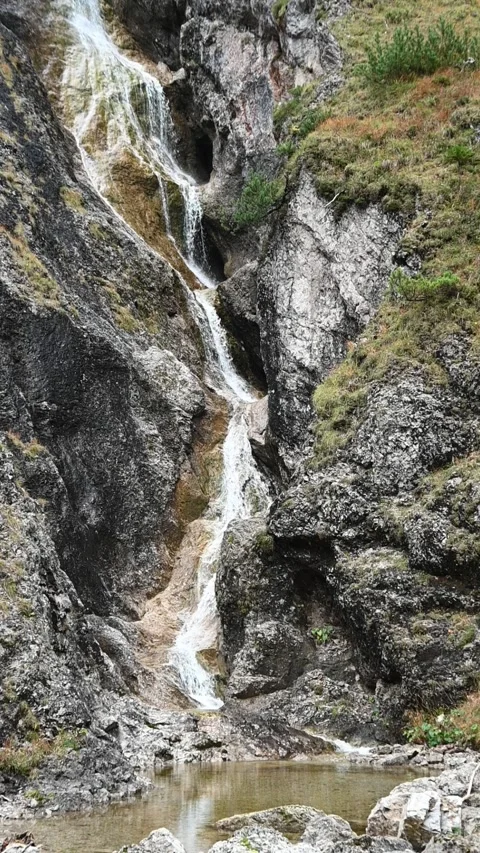 Vertical shot of a stepped waterfall in autumn, slow motion Stock Footage 260896170