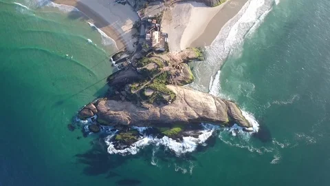 Vertical shot of stone with waves crashing on the shore. Stock Footage 81133097