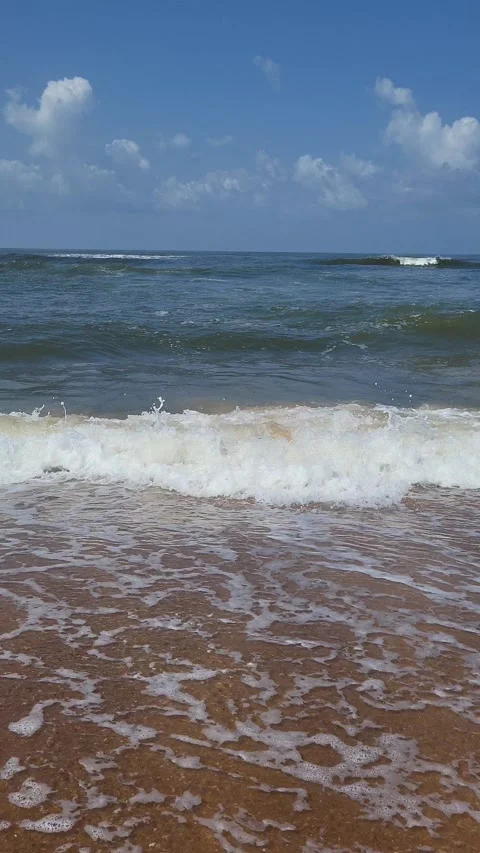 Vertical Shot of Summer beach Sea Waves Gently Crashing on Goa's Sandy Shores Stock Footage 285717397