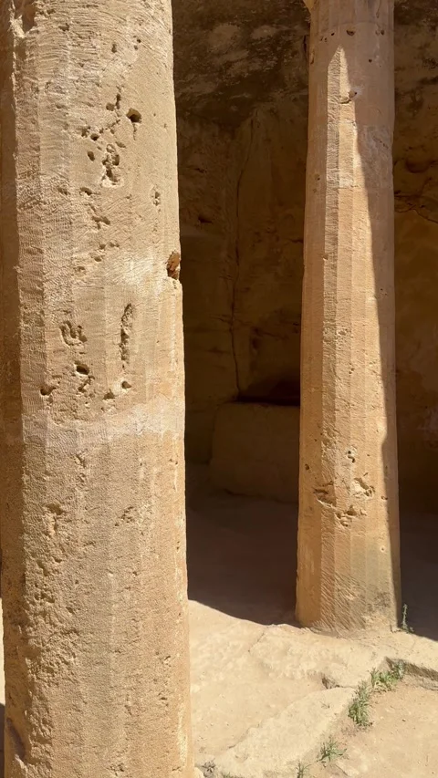 Vertical shot of a sunken courtyard with stone pillars at ancient ruins site Stock Footage 337370116