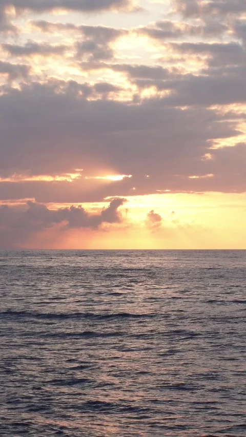 Vertical shot of sunrise between clouds over the sea Stock Footage 297083144