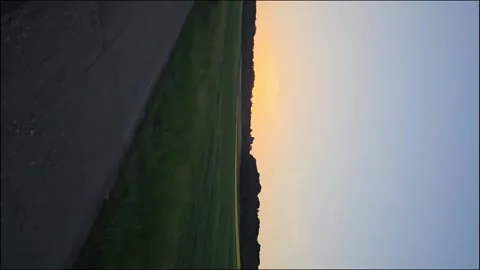 Vertical shot of sunset over field and Autobahn Stock Footage 338164612