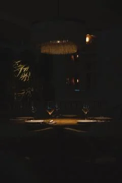 A vertical shot of a table set in a restaurant with silverware, napkins, plat Fotos de archivo