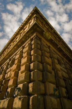 Vertical shot of a tall angular stone building Fotos de archivo