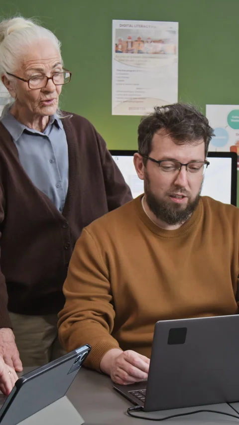 Vertical Shot of Teacher Using Laptop in Computer Literacy Class Stock Footage 333708779