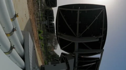 Vertical shot of Time-lapse shot behind an array of solar collectors tracking Stock Footage 54186484