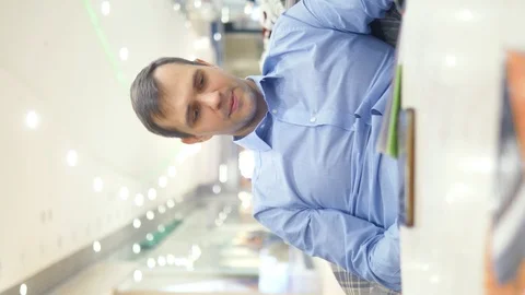 Vertical shot of a tired man at the cafe looking menu Video stock 125530707
