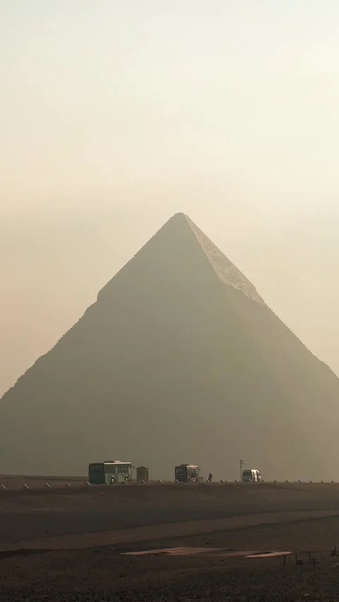 Vertical shot of tourist shuttle buses driving inside the Giza Pyramid Complex Stock Footage 341837946