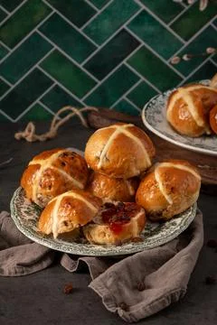 Vertical Shot of Traditional Easter Hot Cross Buns on Vintage Ceramic Plates Stock Photos