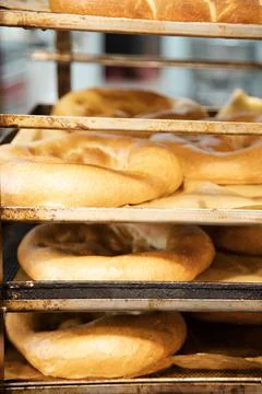 Vertical shot of transporting trays rack with fresh bakery Stock Photos