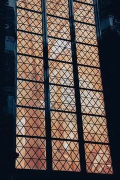 Vertical shot of a triangle-shaped pattern window fence Stock Photos