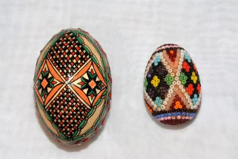 A vertical shot of two different sizes Easter egg with creative patterns and  스톡 사진