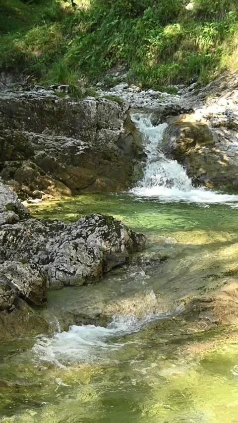 Vertical shot of two small waterfalls from a mountain stream in slow motion Stock-Footage 260881915