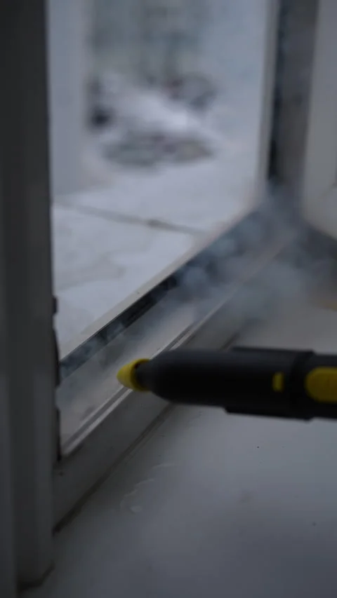Vertical shot of using steam cleaner to remove dirt and grime from window frames Stock Footage 293842590