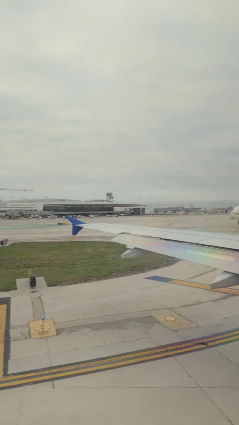 Vertical shot view of AirPlane drive on runway in Chicago Airport. Wide view Stock Footage 279772339