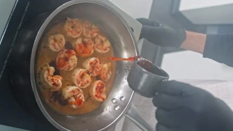 Vertical shot, View of cooking fried roasted shrimps in frying pan. Close-up Stock Footage 230562583