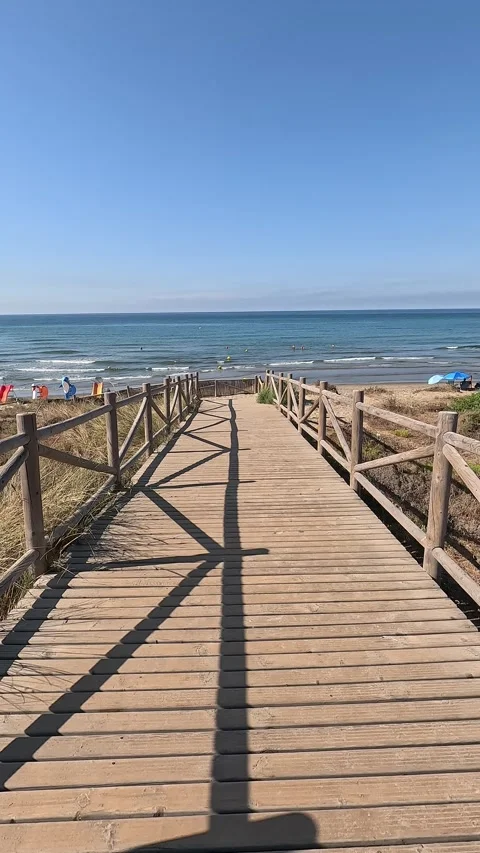 Vertical shot walking a ramp towards the beach Stock Footage 297082923