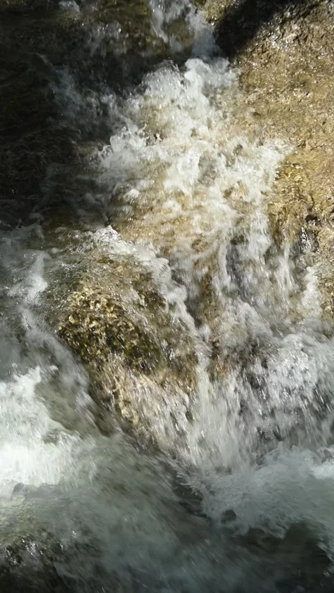 Vertical shot of water from a mountain stream running over rocks Stock-Footage 260912125
