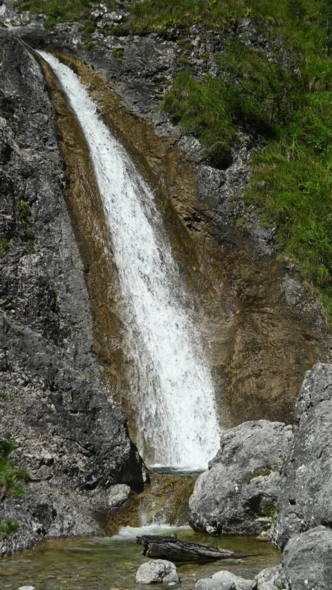 Vertical shot of a waterfall in an alpine environment Stock-Footage 260889281