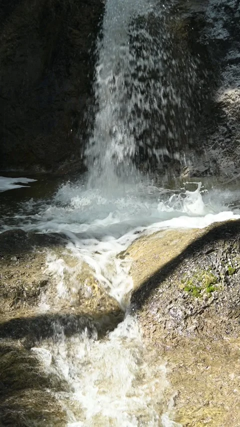 Vertical shot of a waterfall falling into a pond Video stock 260909778