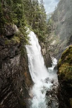Vertical shot of a waterfall in the forest Foto stock