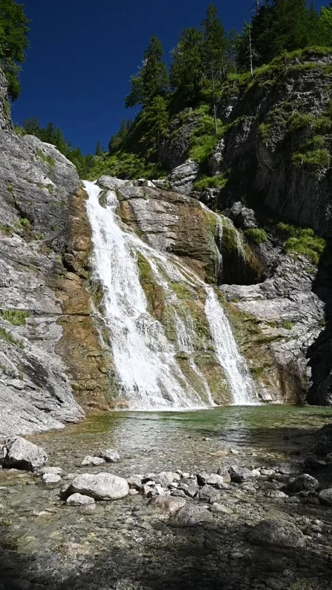 Vertical shot of a waterfall with a mountain stream in summer, slow motion Stock-Footage 260878498