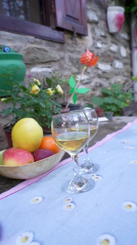 Vertical Shot: Wine, Fruit, and Rustic Table Setting in Village Garden Stock Footage 323403235