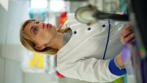 A vertical shot of a woman explaining something while looking at the screen. Stock Footage 265253975