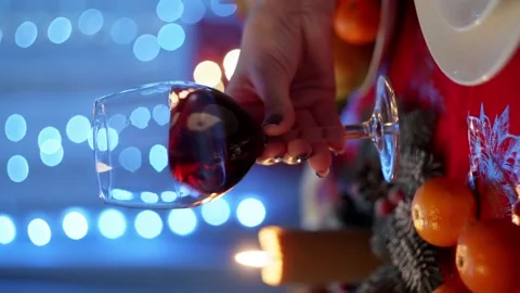 A vertical shot of a woman's hand taking a glass of wine. Stock Footage 259083413