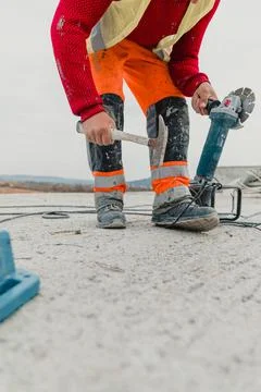 Vertical shot of a worker doing installation work during construction Stock Photos