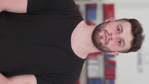 Vertical shot of young man looking serious at camera Stock Footage 277295331