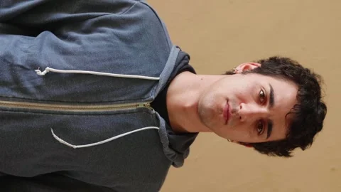 Vertical shot of young man looking serenely at camera Stock Footage 277306146