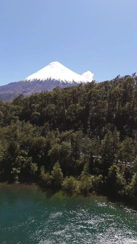 Vertical Side Parallax Over Emerald River and Forest with Osorno Volcano Stock Footage 326057552