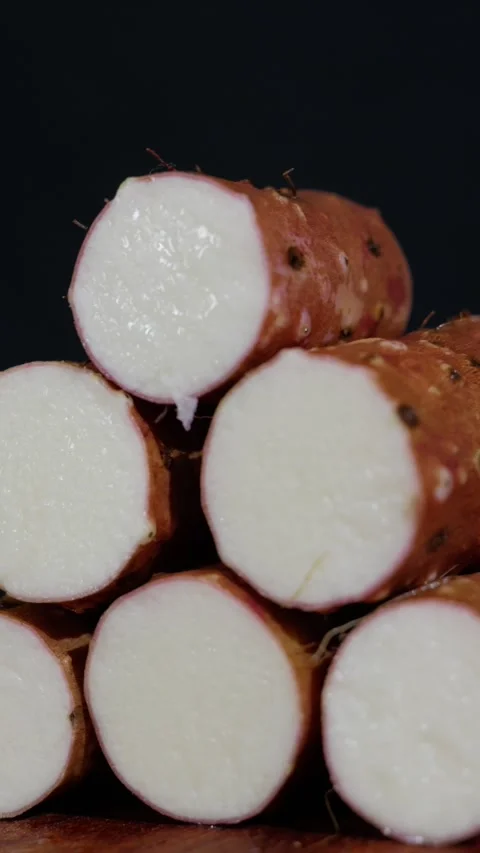 Vertical: Side profile of a pile of fresh Chinese yams stacked together. Stock Footage 341836883