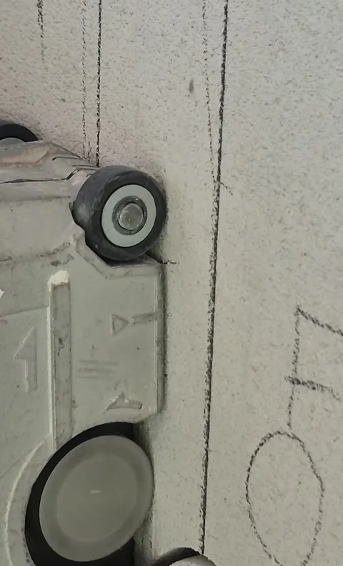 Vertical side view close-up of electrician using wall chaser 스톡 동영상 345665606