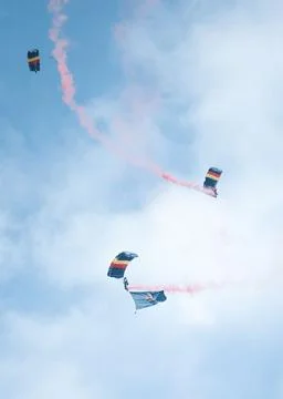 Vertical of skydivers diving with a parachute from the cloudy sky Foto stock