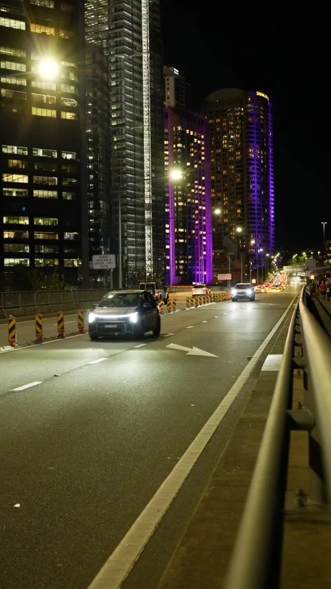 Vertical Skyscrapers turn different colours and Sydney traffic 6K Stock Footage 310375149
