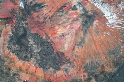 Vertical slagheap texture with eroded orange and grey mineral strata Stock Photos