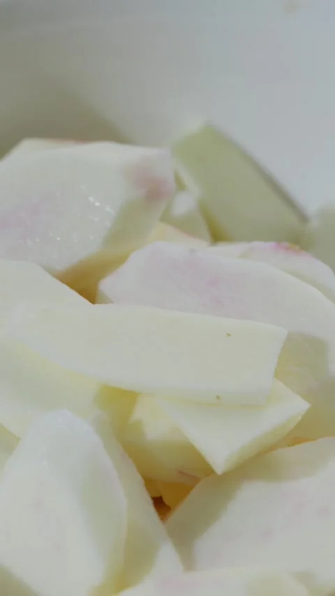 Vertical: Sliced pieces of peeled white Chinese yam laid out. Stock Footage 341837124