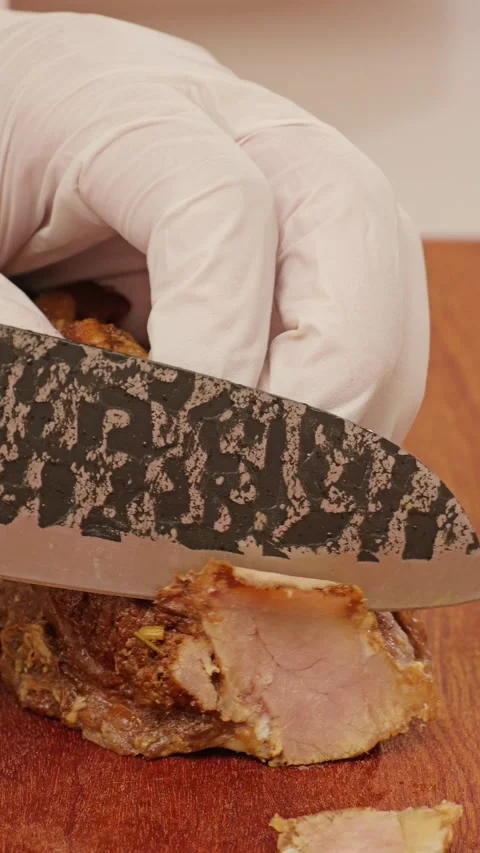 Vertical Slicing braised beef with a kitchen knife. Stock Footage 343327570