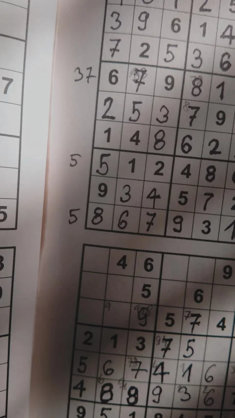 Vertical Slide shot reveals completed brain teaser number puzzle grid Stock Footage 313266114